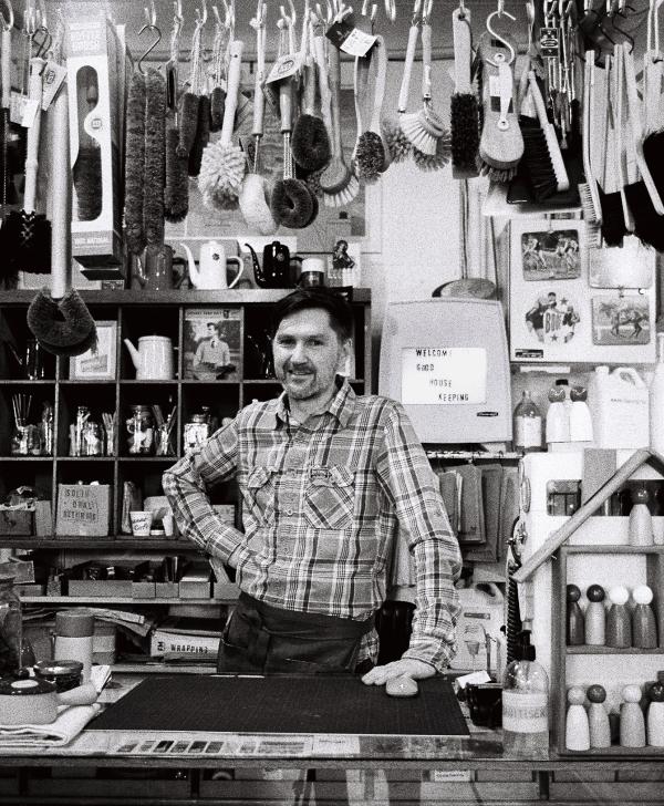 Black and white photograph by Hamish Thompson. Shopkeeper at Good Housekeeping, Cuba Street.