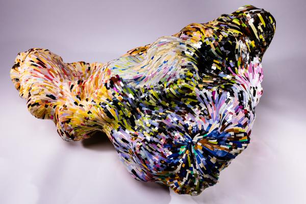 A piece by Erin Jaeger-Freeborn, made from thousands of hand-cut pieces of paper roll together into a multi-coloured abstract form