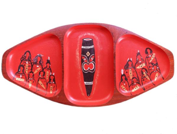 A red wooden dish with Māori art painted on