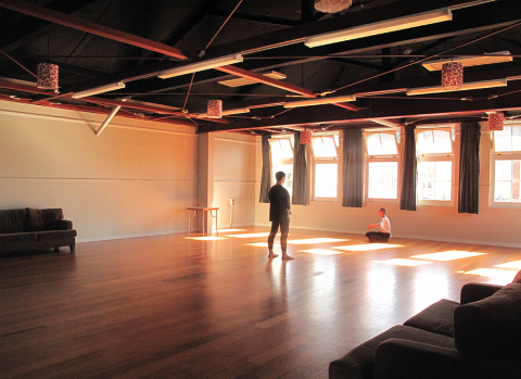 Two dancers practice in the activity hall